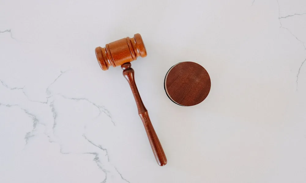 A gavel on a desk, representing personal guarantees and debentures in invoice finance