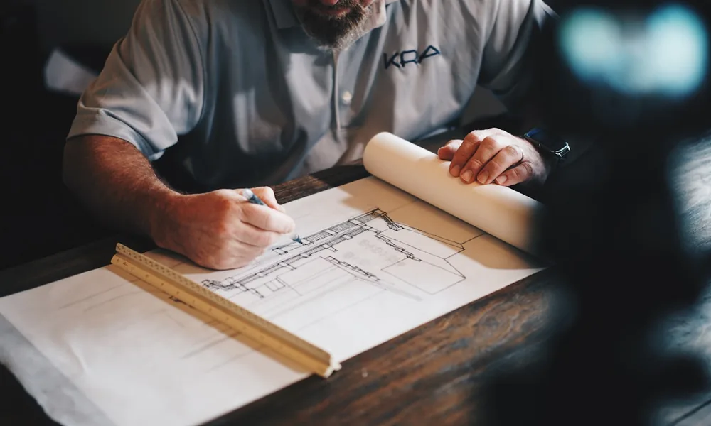 A finance professional reviewing paperwork at a desk, choosing how much of the ledger to fund