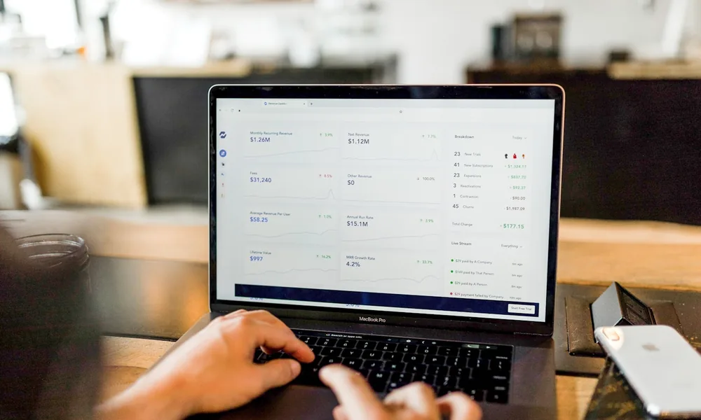 A business owner managing a finance facility on a laptop while switching providers
