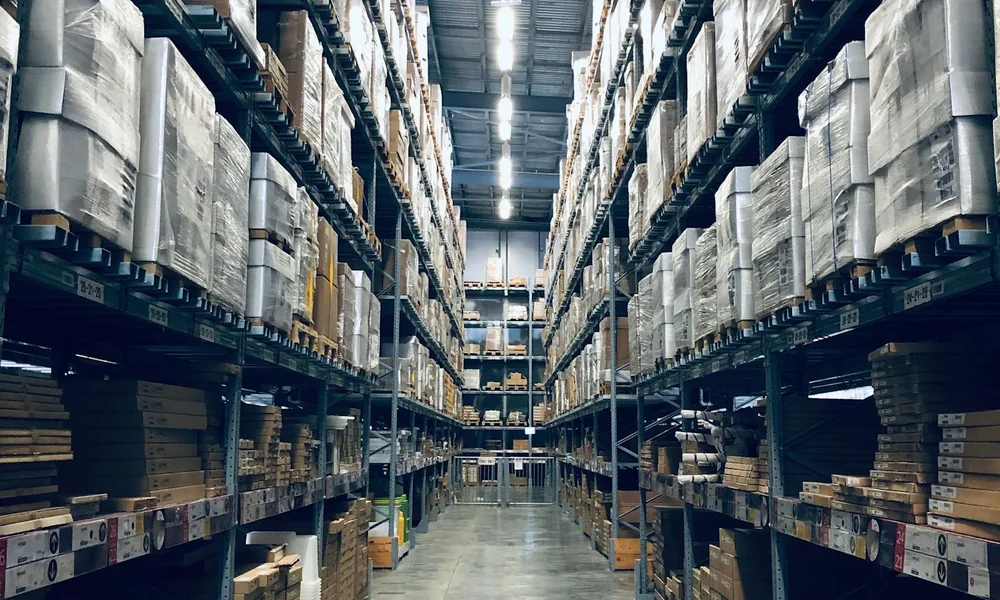 A wholesale distribution warehouse with stocked aisles